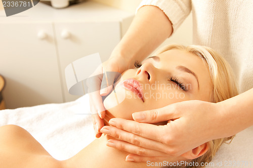 Image of beautiful woman in massage salon