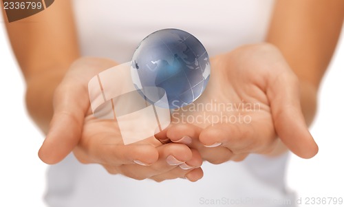 Image of woman hands holding earth globe