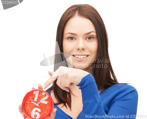 Image of woman holding alarm clock