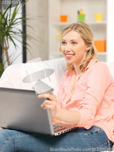 Image of happy woman with laptop computer and credit card