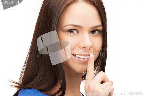 Image of happy woman with finger on lips