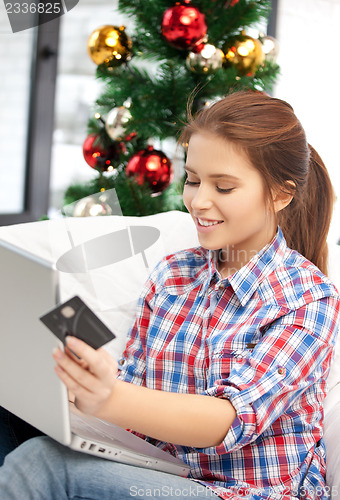 Image of woman with laptop computer and credit card