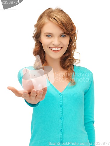 Image of teenage girl with piggy bank