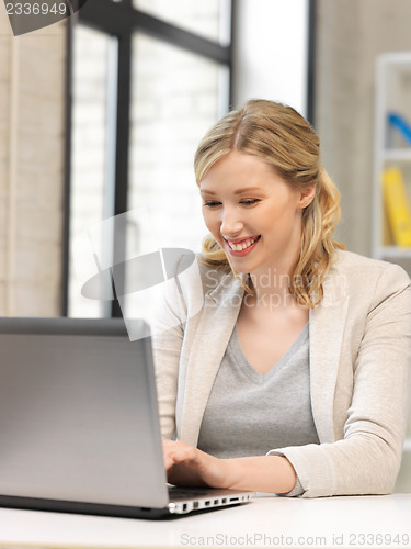 Image of happy woman with laptop computer