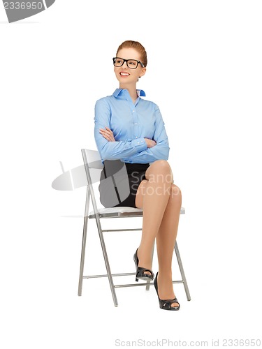 Image of happy and smiling woman on a chair