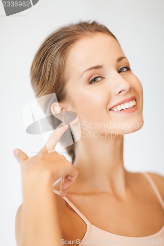 Image of woman pointing to ear