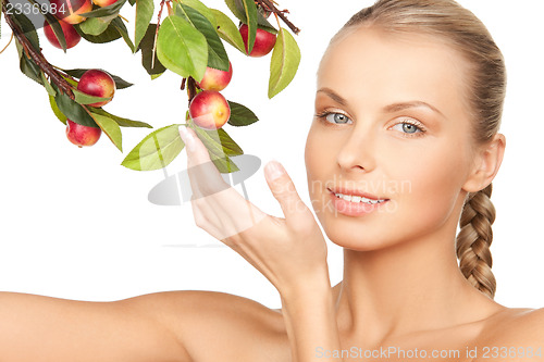 Image of lovely woman with apple twig
