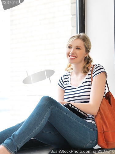 Image of happy and smiling teenage girl with laptop