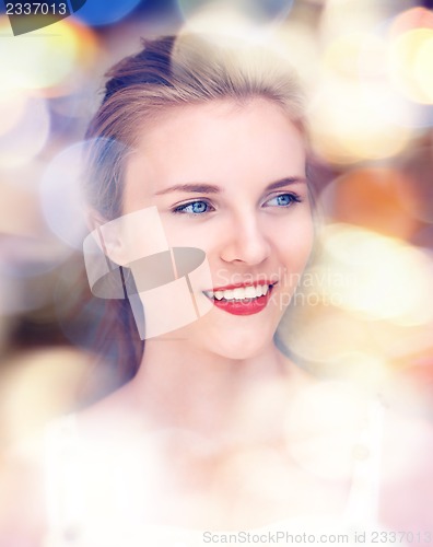 Image of happy and smiling teenage girl with city lights