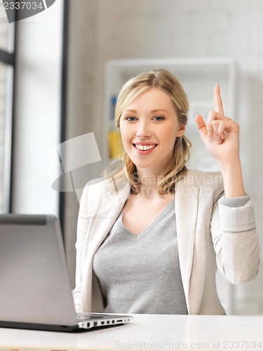 Image of woman with laptop and finger up