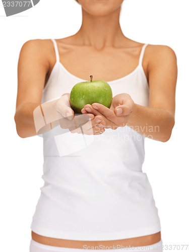 Image of female hands with green apple