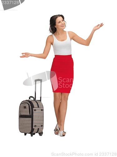 Image of happy woman with suitcase greeting