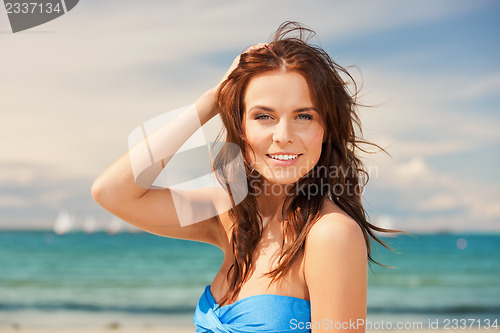 Image of happy smiling woman on the beach