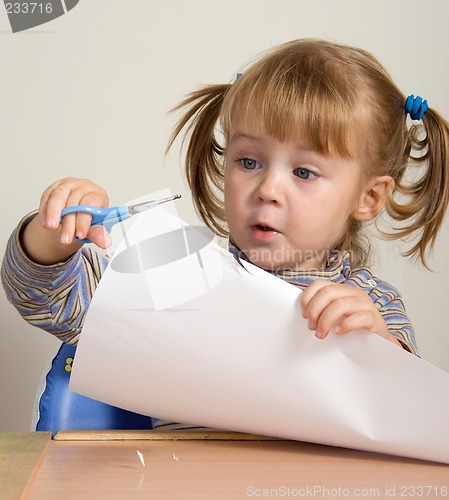 Image of child cutting paper