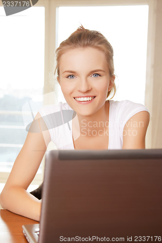 Image of happy teenage girl with laptop computer