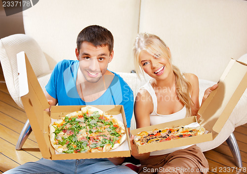 Image of romantic couple eating pizza at home