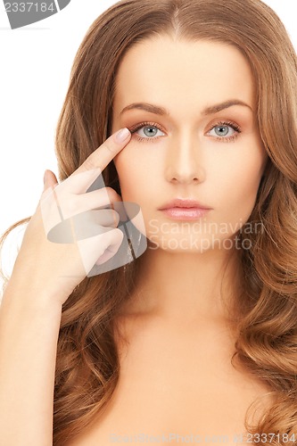 Image of beautiful woman pointing to eye