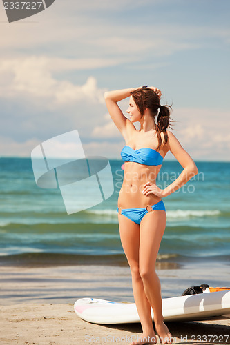 Image of happy woman with wind surf on the beach