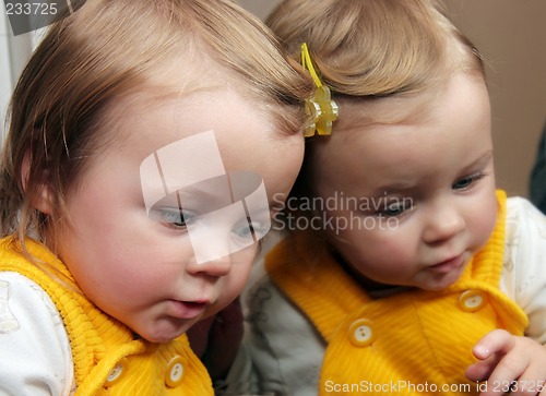 Image of child behind mirror