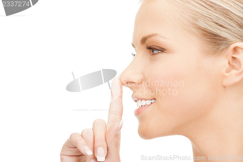 Image of happy woman with finger on lips