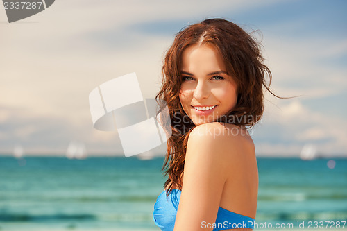 Image of happy smiling woman on the beach
