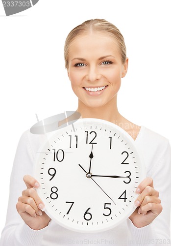 Image of woman holding big clock