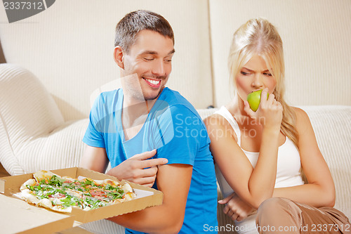 Image of couple eating different food