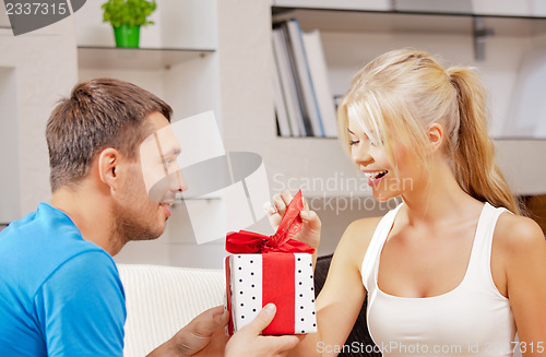 Image of happy romantic couple with gift