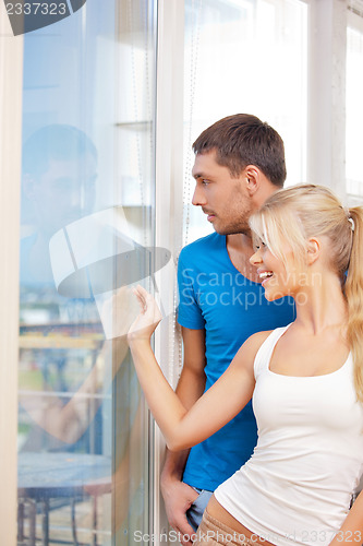 Image of happy couple at the window