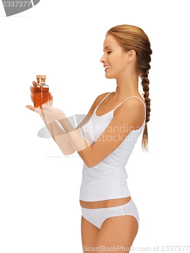 Image of woman with oil bottle