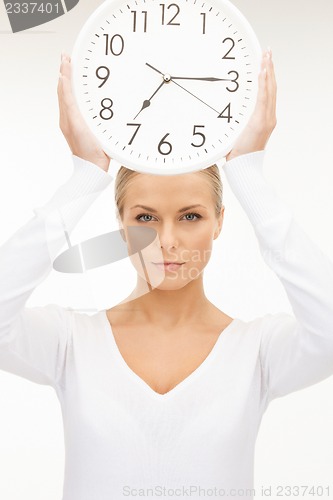 Image of woman holding big clock