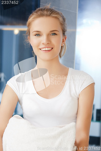 Image of smiling teenage girl with towels