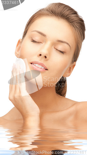 Image of beautiful woman with cotton pad