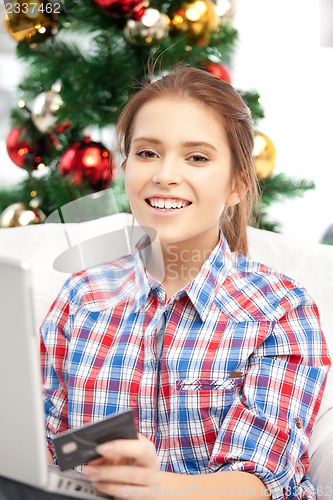 Image of woman with laptop computer and credit card