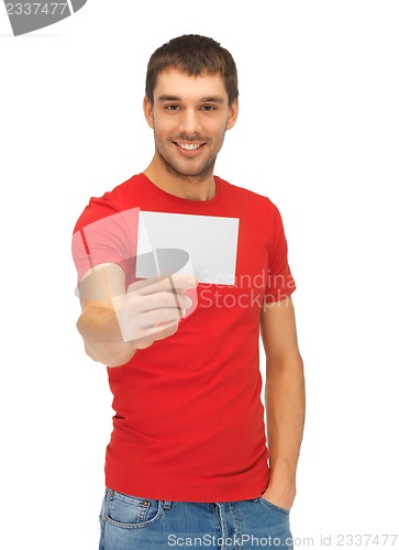 Image of handsome man with note card