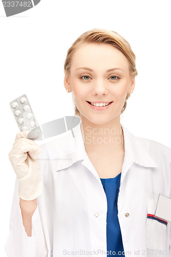 Image of attractive female doctor with pills