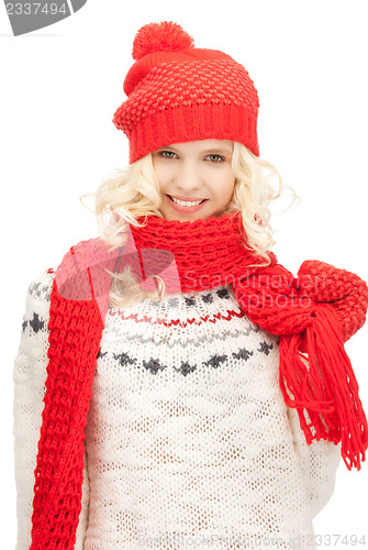 Image of beautiful woman in hat, muffler and mittens