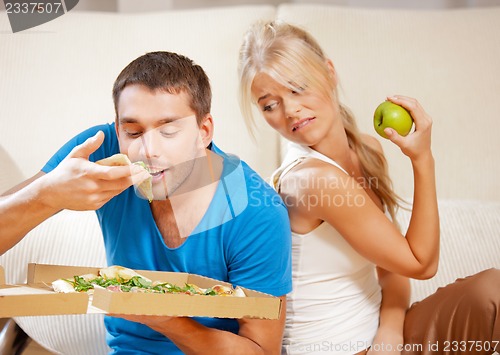 Image of couple eating different food