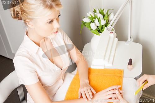 Image of woman having a manicure at the salon