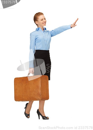 Image of hitch-hiking woman with suitcase