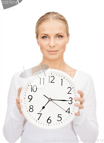 Image of woman holding big clock