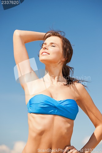 Image of happy smiling woman on the beach