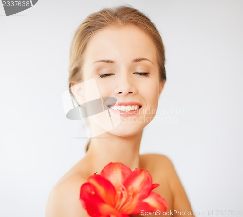 Image of lovely woman with lily flower