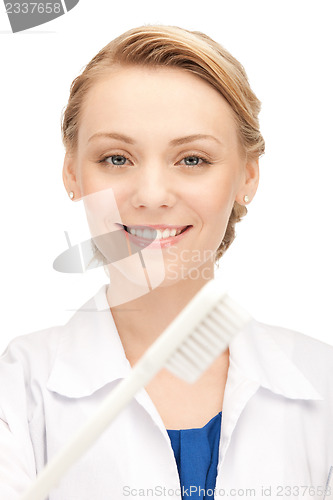 Image of attractive female doctor with toothbrush