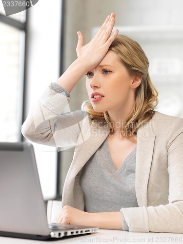 Image of stressed woman with laptop computer