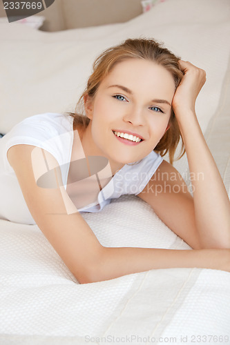 Image of smiling teenage girl on a bed