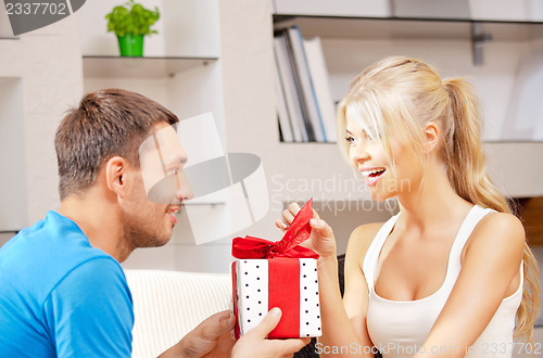 Image of happy romantic couple with gift