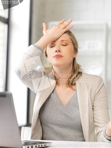 Image of stressed woman with laptop computer