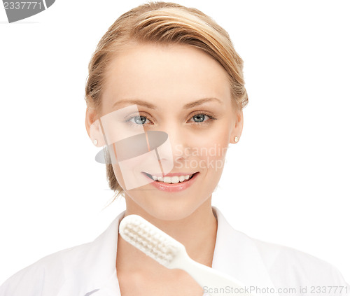 Image of attractive female doctor with toothbrush