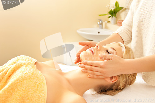 Image of beautiful woman in massage salon